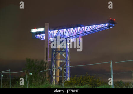 Clydebank, Scotland, UK. 24th May, 2017. The symbol of Clyde shipbuilding the Titan Crane lights up white in honour of the of Manchester terror attack victims. West Dunbartonshire Council took the decision to light up the site on Tuesday evening. It will remain lit up from dusk on Tuesday, May 23rd until  this morning. Credit: gerard ferry/Alamy Live News Stock Photo