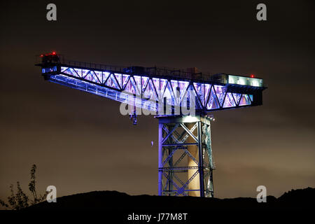 Clydebank, Scotland, UK. 24th May, 2017. The symbol of Clyde shipbuilding the Titan Crane lights up white in honour of the of Manchester terror attack victims. West Dunbartonshire Council took the decision to light up the site on Tuesday evening. It will remain lit up from dusk on Tuesday, May 23rd until  this morning Credit: gerard ferry/Alamy Live News