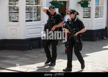 Windsor, UK. 24th May, 2017. Heavily armed police officers patrol in the town centre. The Changing of the Guard ceremony by the 1st Battalion of the Coldstream Guards was cancelled this morning at short notice in response to the raising of the threat level from severe to critical by the Joint Terrorism Assessment Centre, but increased numbers of police officers were in evidence. Credit: Mark Kerrison/Alamy Live News Stock Photo