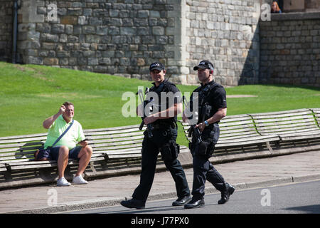 Windsor, UK. 24th May, 2017. Heavily armed police officers patrol in front of Windsor Castle. The Changing of the Guard ceremony by the 1st Battalion of the Coldstream Guards was cancelled this morning at short notice in response to the raising of the threat level from severe to critical by the Joint Terrorism Assessment Centre but increased numbers of police officers were in evidence. Credit: Mark Kerrison/Alamy Live News Stock Photo