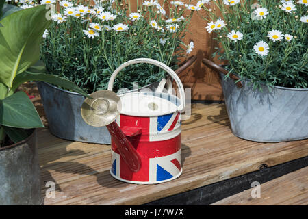 Union jack watering can on a flower display at a flower show. UK Stock Photo