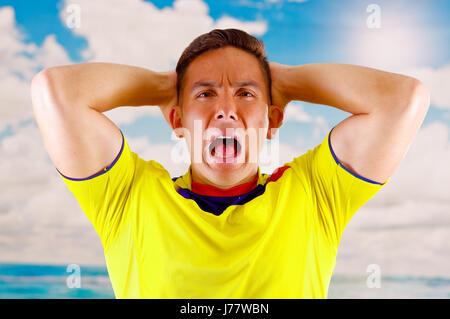 QUITO, ECUADOR -8 OCTOBER, 2016: Young ecuadorian woman wearing official  Marathon football shirt standing facing camera, very engaged body language  watching game with great enthusiasm, blue sky and clouds background Stock  Photo - Alamy