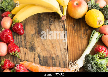 Fruits and Vegetables with Copy Space on Rustic Wooden Background. Stock Photo