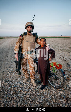 Afghan Boy with British solidier,  Afghanistan Stock Photo