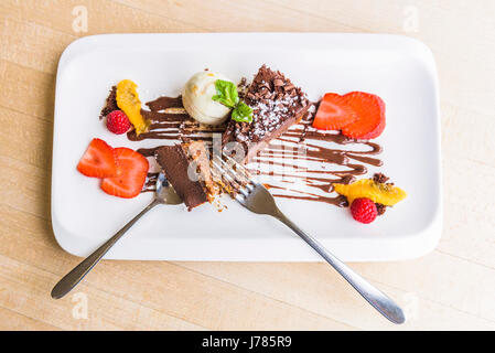 An overhead view of Chocolate Delice with vanilla ice cream; Pudding; Sweet; Food; Indulgence; Luxury; Luxurious; Treat; Dish; Appetising; Appetizing; Stock Photo