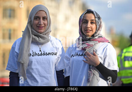 People attend a vigil in Trafalgar Square, London after a 23-year-old man was arrested in connection with the suicide attack which killed 22 people, including children, as fans left a pop concert in Manchester last night. Stock Photo