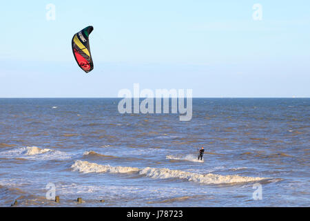 Lone kite surfer enjoying the sunny and windy conditions here at Camber Sands, East Sussex Stock Photo