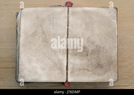 On the table lay an ancient book open on empty pages. Stock Photo