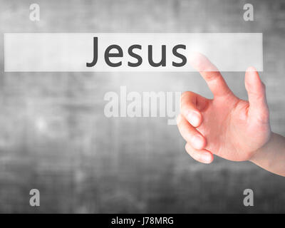 Jesus - Hand pressing a button on blurred background concept . Business, technology, internet concept. Stock Photo Stock Photo