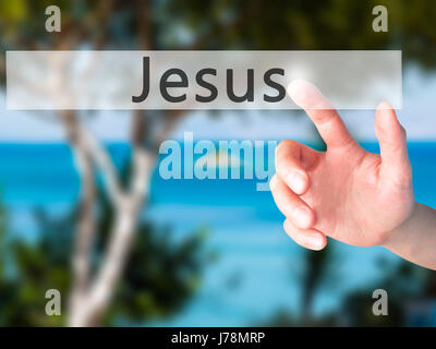 Jesus - Hand pressing a button on blurred background concept . Business, technology, internet concept. Stock Photo Stock Photo