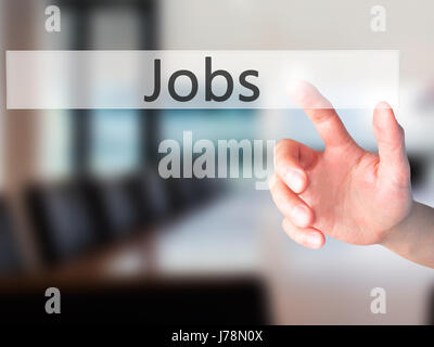 Jobs - Hand pressing a button on blurred background concept . Business, technology, internet concept. Stock Photo Stock Photo