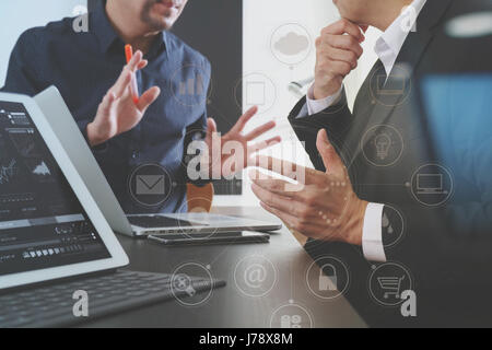 co working team meeting concept,businessman using smart phone and digital tablet and laptop computer in modern office with virtual graph chart and ico Stock Photo