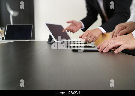 co working team meeting concept,businessman using smart phone and digital tablet and laptop computer in modern office Stock Photo