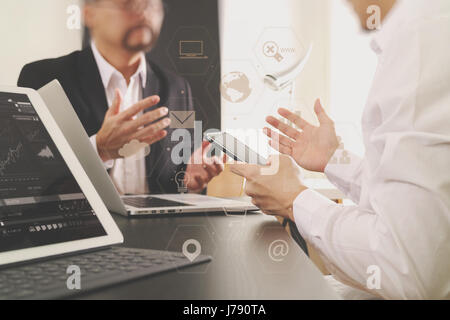 Co working team meeting concept,businessman using smart phone and digital tablet and laptop computer in modern office with virtual graph chart and ico Stock Photo