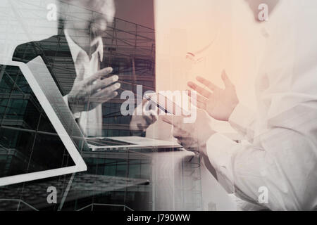 Co working team meeting concept,businessman using smart phone and digital tablet and laptop computer in modern office with London city exposure Stock Photo
