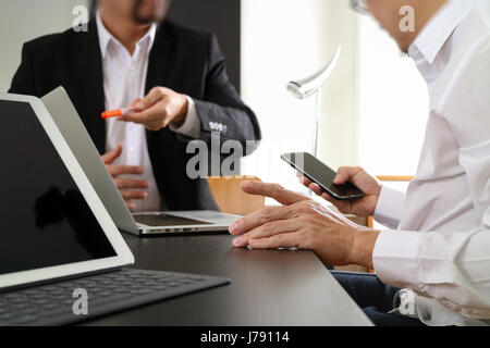co working team meeting concept,businessman using smart phone and digital tablet and laptop computer in modern office Stock Photo