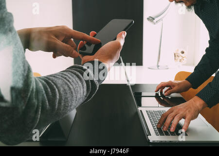 co working team meeting concept,businessman using smart phone and digital tablet and laptop computer in modern office Stock Photo