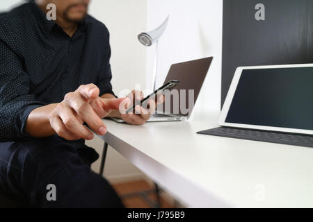 businessman working with smart phone and digital tablet and laptop computer in modern office Stock Photo