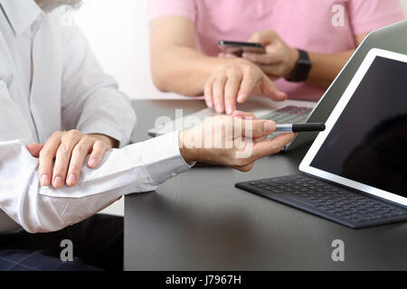 co working team meeting concept,businessman using smart phone and digital tablet and laptop computer in modern office Stock Photo