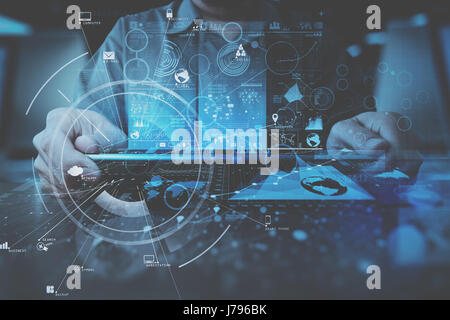 businessman hand working with modern digital tablet computer in modern office with virtual icon diagram Stock Photo