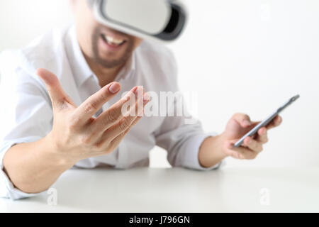 businessman wearing virtual reality goggles in modern office with Smartphone using with VR headset Stock Photo