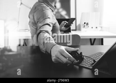 businessman using VOIP headset with digital tablet computer and smart phone,as concept communication and call center or customer service help desk in  Stock Photo