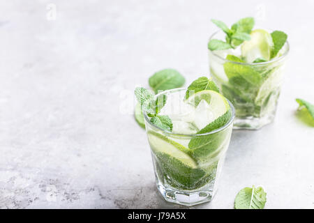 Mojito cocktail on light gray background close up, refreshing summer drink
