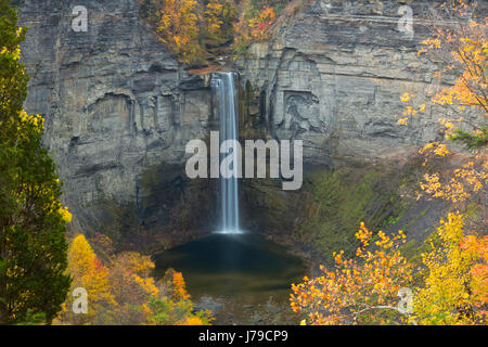 Fall color surrounds Taughannock Falls at Taughannock Falls State Park in New York. USA