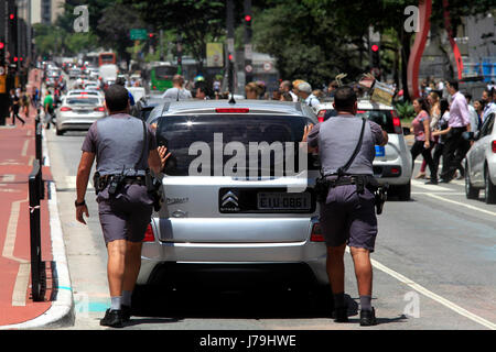 Policemen pushing broken down car on Paulista avenue at São Paulo city - Brazil Stock Photo