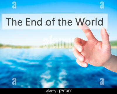 The End of the World - Hand pressing a button on blurred background concept . Business, technology, internet concept. Stock Photo Stock Photo