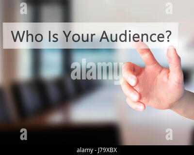 Who Is Your Audience? - Hand pressing a button on blurred background concept . Business, technology, internet concept. Stock Photo Stock Photo