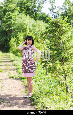 Pregnant woman posing in the summer park. Stock Photo