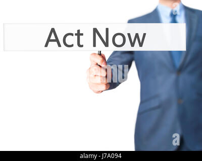 Act Now - Business man showing sign. Business, technology, internet concept. Stock Photo Stock Photo