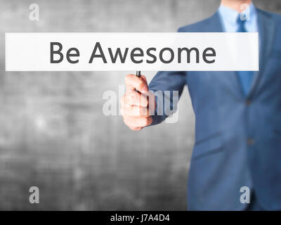 Be Awesome - Business man showing sign. Business, technology, internet concept. Stock Photo Stock Photo