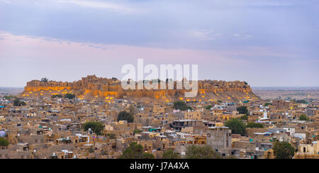 Jaisalmer cityscape at dusk. The majestic fort dominating the city. Scenic travel destination and famous tourist attraction in the Thar desert, Rajast Stock Photo