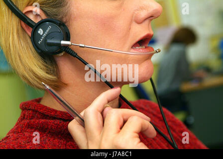 Female call centre worker with headset Stock Photo