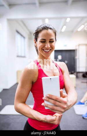 Young female athete taking selfies in gym Stock Photo - Alamy