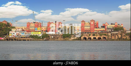 Cityscape and Howrah Station as viewed from Mallick Ghat on the other side of river Hooghly. Howrah railway station is a historic colonial structure. Stock Photo