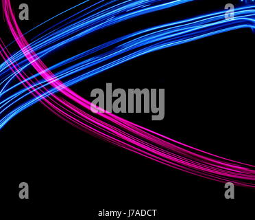 Long exposure photograph of neon pink and blue colour in an abstract pattern against a black background. Light painting photography, abstract colour Stock Photo