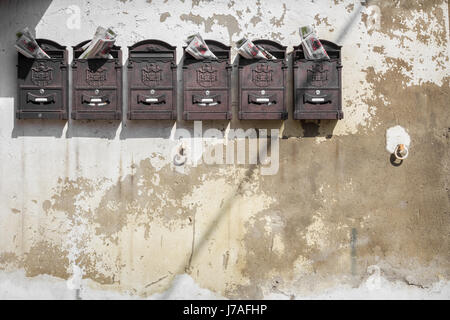 Old mailboxes hanging on the wall Stock Photo