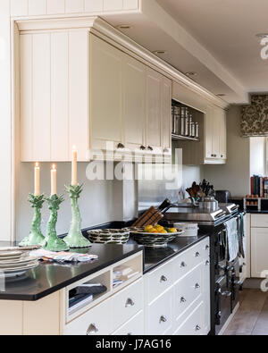 Elegant off-white kitchen with black stone worktops. Stock Photo