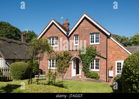 External rear facade of idyllic Grade II brick cottage Stock Photo