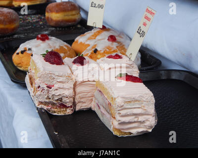 Cakes and Pastries on sale on a market stall Stock Photo