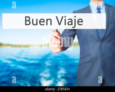 Buen Viaje (Good Trip in Spanish) - Businessman hand holding sign. Business, technology, internet concept. Stock Photo Stock Photo