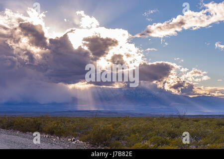 Sun Beams Through Clouds Over Arizona Desert Stock Photo