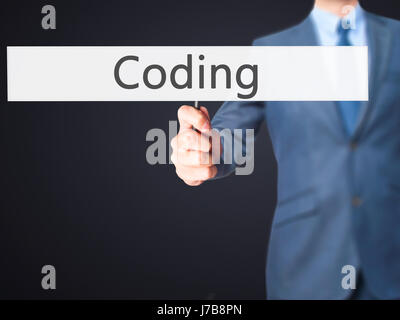 Coding - Business man showing sign. Business, technology, internet concept. Stock Photo Stock Photo
