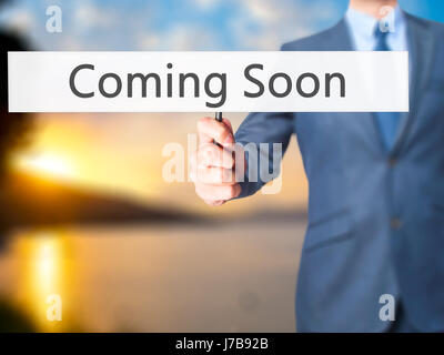 Coming Soon - Business man showing sign. Business, technology, internet concept. Stock Photo Stock Photo