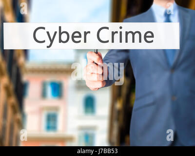 Cyber Crime - Businessman hand holding sign. Business, technology, internet concept. Stock Photo Stock Photo