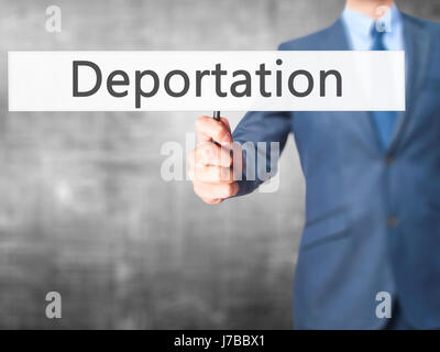 Deportation - Businessman hand holding sign. Business, technology, internet concept. Stock Photo Stock Photo