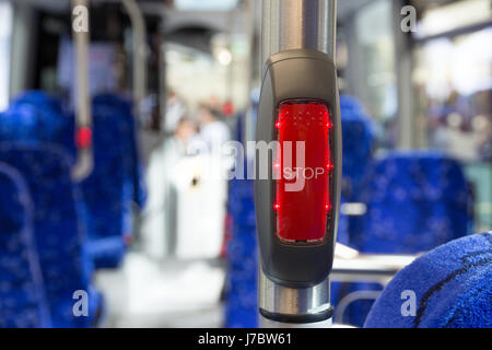 Illuminated stop button in a modern bus. Stock Photo